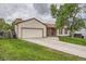 Traditional home with a spacious driveway, attached garage and inviting lawn at 18240 E Mexico Pl, Aurora, CO 80017