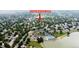 Aerial view of the property showcasing neighborhood amenities, including a pool, lake, tennis courts, and mature trees at 1013 E 130Th Dr, Thornton, CO 80241