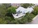 Aerial view of the home featuring a large deck, lush landscaping, and a light gray roof at 1013 E 130Th Dr, Thornton, CO 80241