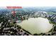 Aerial view of the property showcasing its location near a lake, green spaces, and residential area at 1013 E 130Th Dr, Thornton, CO 80241