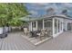 Outdoor back deck featuring patio furniture, an umbrella, and a sliding door leading into the sun room at 1013 E 130Th Dr, Thornton, CO 80241
