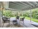 Covered back patio featuring outdoor seating, a fire pit, a hammock, and views of the backyard at 1013 E 130Th Dr, Thornton, CO 80241