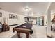 Finished basement featuring a pool table, carpeted floors, and sliding door access to the backyard at 1013 E 130Th Dr, Thornton, CO 80241