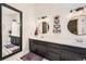Elegant bathroom featuring dual vanities, stylish fixtures, round mirrors, modern lighting, and glass-enclosed shower at 1013 E 130Th Dr, Thornton, CO 80241