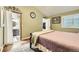 Bedroom featuring a connecting bathroom and closet space, with soft green walls, and a plush patterned carpet at 1013 E 130Th Dr, Thornton, CO 80241