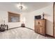 Cozy bedroom featuring a wardrobe, carpeted floors, a window with coverings, and simple decor at 1013 E 130Th Dr, Thornton, CO 80241