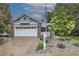 Charming single-Gathering home with brick accents, white garage door, and landscaped front yard with a white picket fence at 1013 E 130Th Dr, Thornton, CO 80241