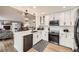 Modern, spacious kitchen featuring stainless steel appliances and a view of the living room at 1013 E 130Th Dr, Thornton, CO 80241