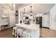 Modern kitchen features white cabinets, stainless steel appliances, and stylish pendant lighting at 1013 E 130Th Dr, Thornton, CO 80241