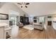 Spacious living room with vaulted ceiling, fireplace, and open access to kitchen and dining area at 1013 E 130Th Dr, Thornton, CO 80241