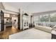 Open-concept living room featuring hardwood floors, a light white couch, and a peek into the dining and kitchen area at 1013 E 130Th Dr, Thornton, CO 80241