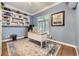 Inviting office space with custom built-ins, a bright window, and a comfortable work area on hardwood floors at 1013 E 130Th Dr, Thornton, CO 80241