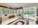 Bright sunroom featuring multiple windows, access to the backyard, and neutral-colored walls at 1013 E 130Th Dr, Thornton, CO 80241