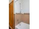 Bathroom with tub and shower, grab bars, and tiled walls at 1000 Collyer St, Longmont, CO 80501