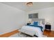 Bright bedroom with a queen bed, hardwood floors, and two nightstands at 1000 Collyer St, Longmont, CO 80501