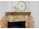 Close up of a stone fireplace with a gold clock above at 1000 Collyer St, Longmont, CO 80501