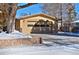 Attached brick garage with a window and snow on the ground at 1000 Collyer St, Longmont, CO 80501