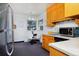 Cozy kitchen featuring wood cabinets, stainless steel appliances, and a small breakfast nook at 1000 Collyer St, Longmont, CO 80501