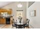 Cozy dining area with a glass table, hardwood floors, and a view to the outside at 2910 S Racine St, Aurora, CO 80014