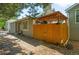 Charming home exterior featuring covered patio, stone accents, and neat landscaping at 2910 S Racine St, Aurora, CO 80014