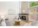 Inviting living room with a stone fireplace, neutral decor, and natural light streaming in at 2910 S Racine St, Aurora, CO 80014