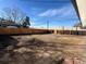 Large fenced backyard with a beautiful shade tree, perfect for Gathering gatherings and relaxing outdoors at 4785 Estes St, Wheat Ridge, CO 80033