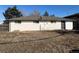 A view of the back of the house, which is painted white, and has a small yard at 4785 Estes St, Wheat Ridge, CO 80033