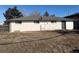 A view of the back of the house, which is painted white, and has a small yard at 4785 Estes St, Wheat Ridge, CO 80033