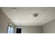 Unfinished basement ceiling featuring drop ceiling tiles and fluorescent light at 4785 Estes St, Wheat Ridge, CO 80033