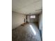 Spacious basement featuring neutral carpet, drop ceiling, and natural light from sliding glass door to the backyard at 4785 Estes St, Wheat Ridge, CO 80033