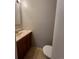 Half bathroom featuring a sink and vanity, tile floors, and neutral paint at 4785 Estes St, Wheat Ridge, CO 80033