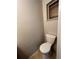 Half bathroom featuring a standard white toilet, tile floors, and neutral paint at 4785 Estes St, Wheat Ridge, CO 80033