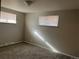 Neutral bedroom featuring carpet, two windows with blinds, and fresh paint at 4785 Estes St, Wheat Ridge, CO 80033