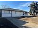 Charming single-story home with a classic white exterior, well-maintained lawn, and a spacious driveway at 4785 Estes St, Wheat Ridge, CO 80033