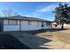 Charming single-story home with a classic white exterior, well-maintained lawn, and a spacious driveway at 4785 Estes St, Wheat Ridge, CO 80033