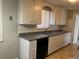 Modest kitchen featuring upper cabinets, stainless steel sink, and essential appliances at 4785 Estes St, Wheat Ridge, CO 80033