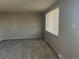 A cozy living room with neutral-toned walls, plush carpeting, and natural light streaming through the window at 4785 Estes St, Wheat Ridge, CO 80033