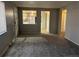 Cozy living room with fresh gray carpet, neutral walls, and an opening providing a glimpse into the well-lit kitchen at 4785 Estes St, Wheat Ridge, CO 80033