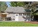 Charming backyard with patio, table, umbrella and well-maintained lawn at 3976 S Washington St, Englewood, CO 80113
