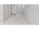 Finished basement area with neutral carpeting, neutral paint and a door at 3976 S Washington St, Englewood, CO 80113