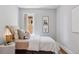 Relaxing bedroom with soft textures, plush bedding, and a bright window at 3976 S Washington St, Englewood, CO 80113