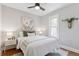 Cozy bedroom featuring a ceiling fan, plush bedding and natural light at 3976 S Washington St, Englewood, CO 80113