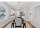 Elegant dining room flowing into the modern kitchen creating a seamless living space for dining and entertaining at 3976 S Washington St, Englewood, CO 80113