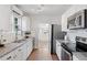 Modern kitchen featuring granite countertops, stainless steel appliances, and plenty of cabinet space at 3976 S Washington St, Englewood, CO 80113