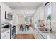 Bright, modern kitchen with stainless steel appliances seamlessly connecting to dining and living areas at 3976 S Washington St, Englewood, CO 80113