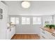 Bright kitchen offering generous counter space and sleek white cabinets for a clean modern look at 3976 S Washington St, Englewood, CO 80113