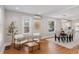 Cozy living room with stylish seating area, leading into the dining room with ample natural light at 3976 S Washington St, Englewood, CO 80113