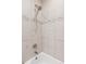 Bathroom tiled shower and bath with shower head and fixtures at 3976 S Washington St, Englewood, CO 80113