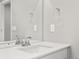 Close-up of a pristine bathroom vanity with a large mirror, sleek faucet, and ample counter space at 559 Homestead Ave, Brighton, CO 80601