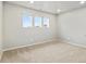 Bright bedroom featuring neutral walls and carpet, illuminated by three windows offering natural light at 559 Homestead Ave, Brighton, CO 80601